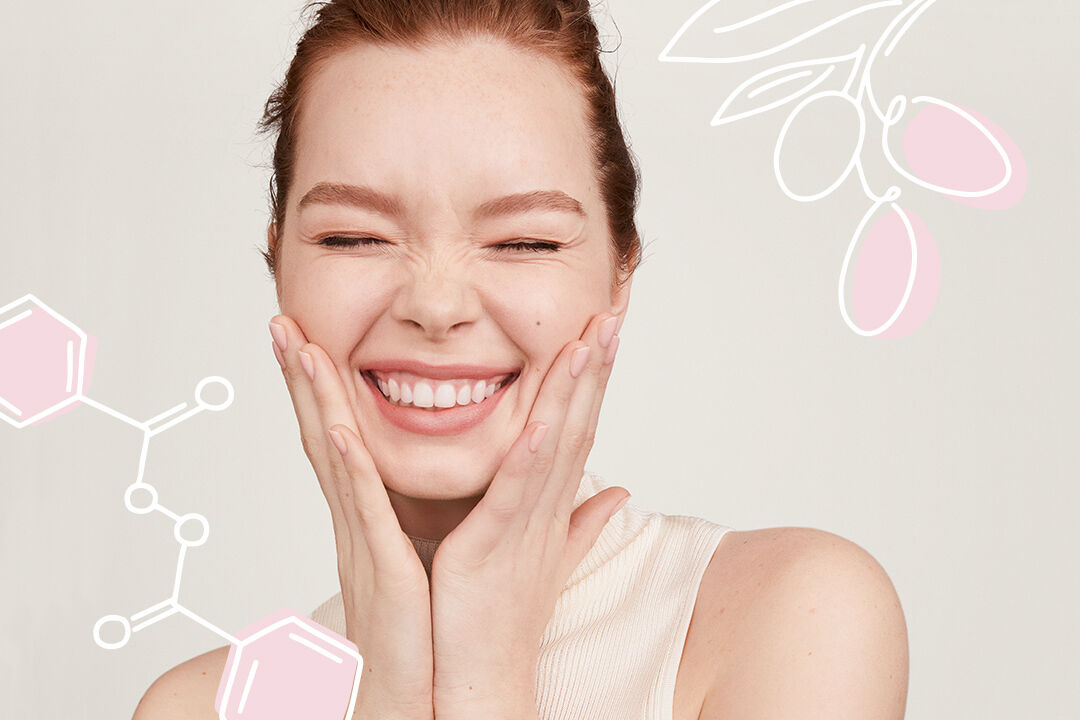 Woman smiling and holding her hands to her cheeks