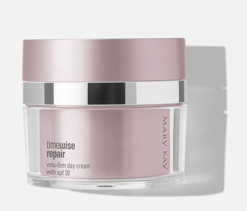A jar of Mary Kay TimeWise Repair Volu-Firm Day Cream With SPF 30 against a gray background. 