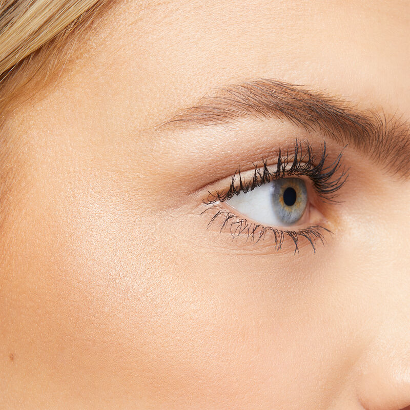 Close-up of fair-skinned model with blonde hair and blue eyes wearing limited-edition Mary Kay Illuminating Highlighter