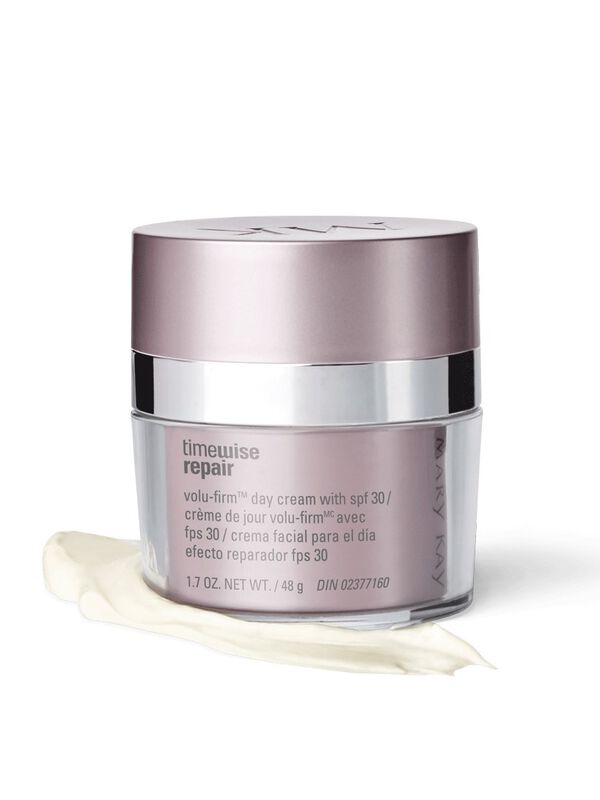 A jar of Mary Kay TimeWise Repair Volu-Firm Day Cream With SPF 30 styled on top of a product rub. 