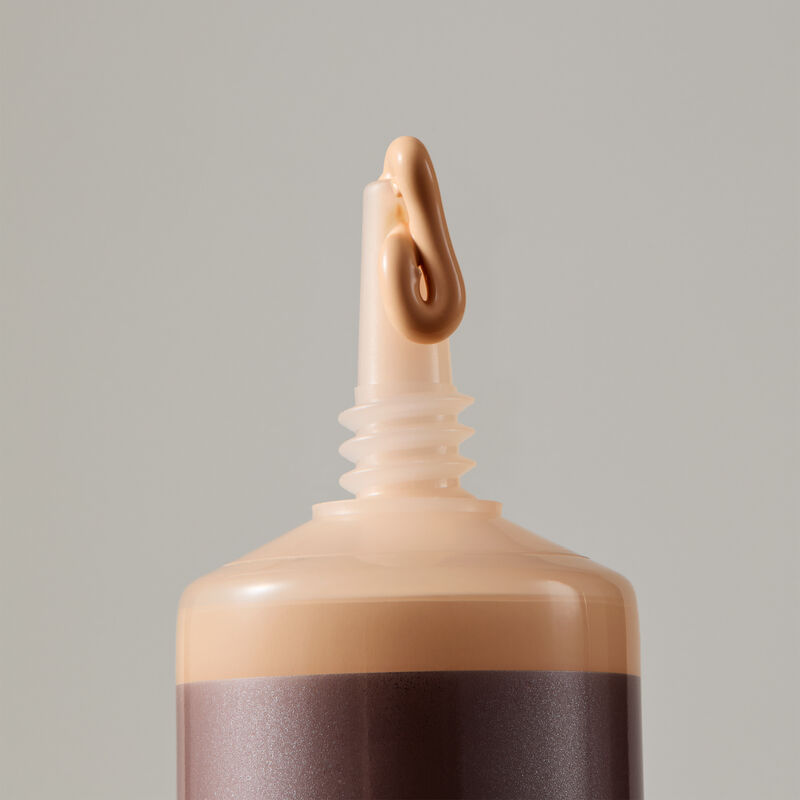 Macro view of TimeWise Luminous 3D Foundation needle-nose applicator dispensing Light 3 shade