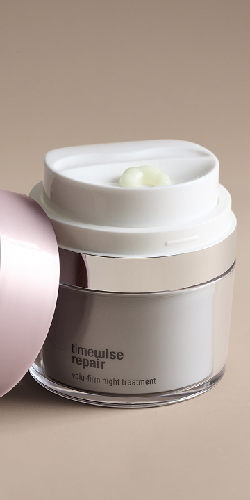 A close up of a woman's face with eye cream.