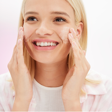 Blonde model applying Mary Kay Hydrating Cleanser to her face