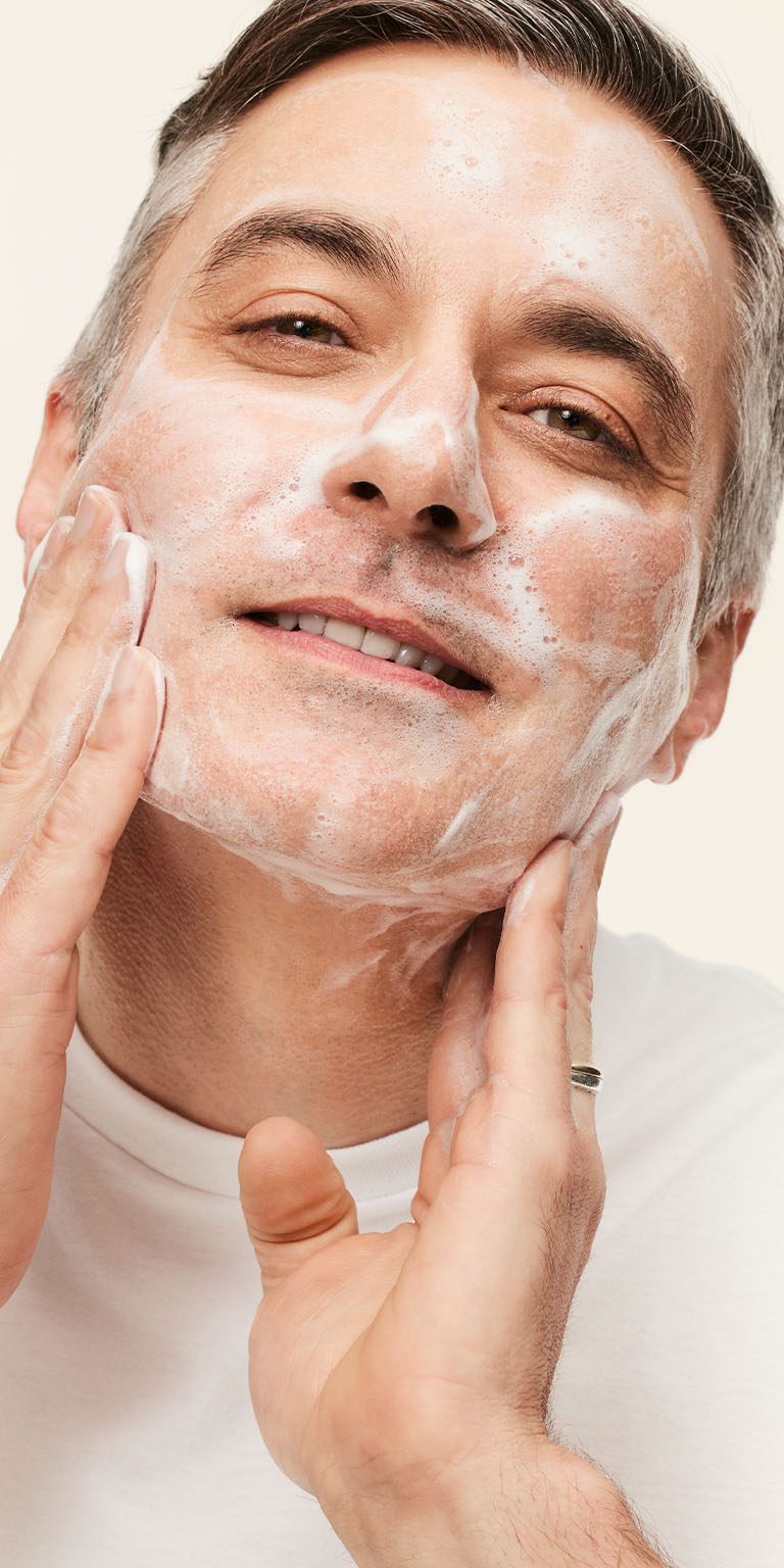 Male model applying MKMens Daily Facial Wash to his face